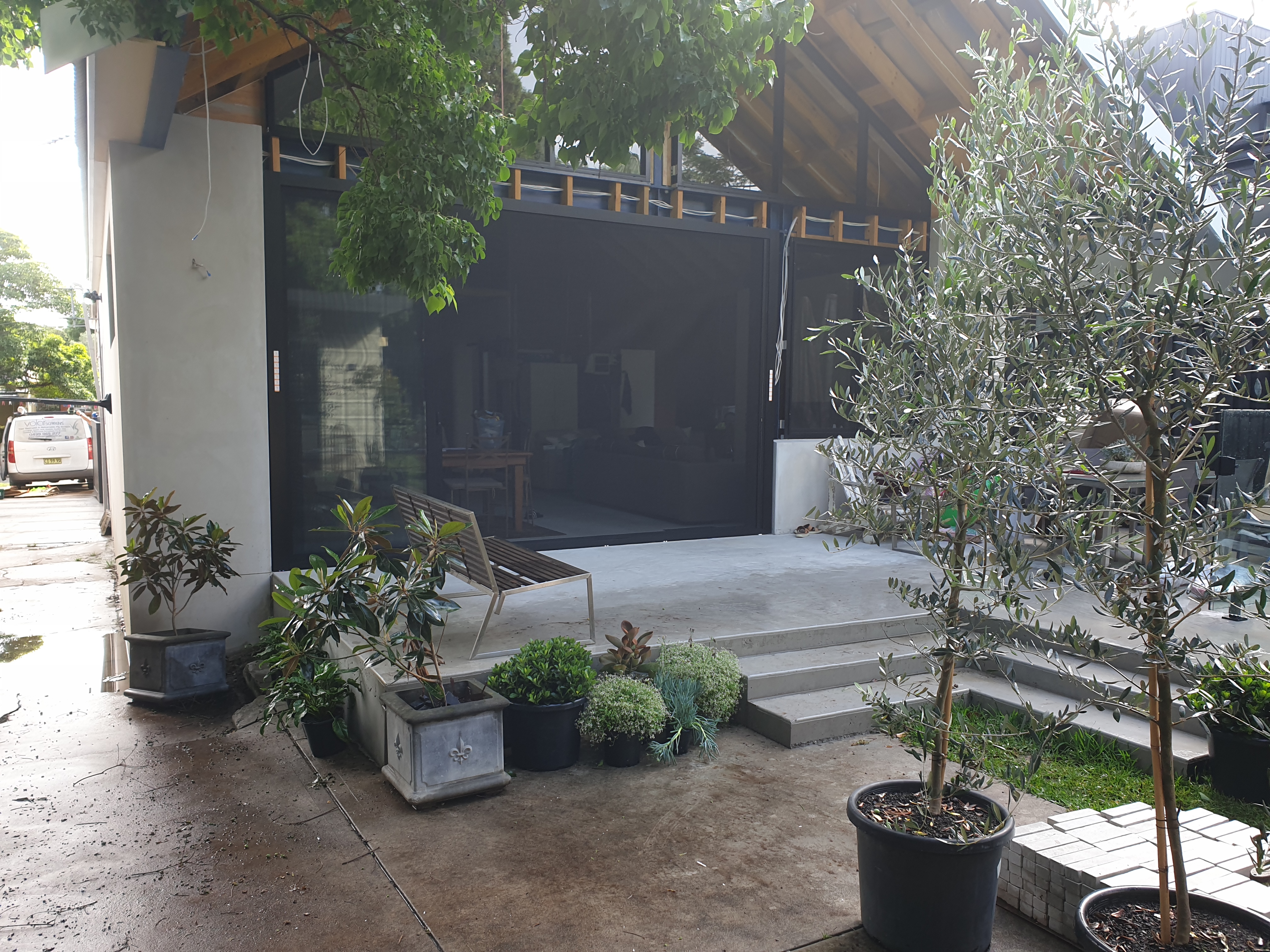 Premium residential interior opening to outdoor area with seamless retractable screens
