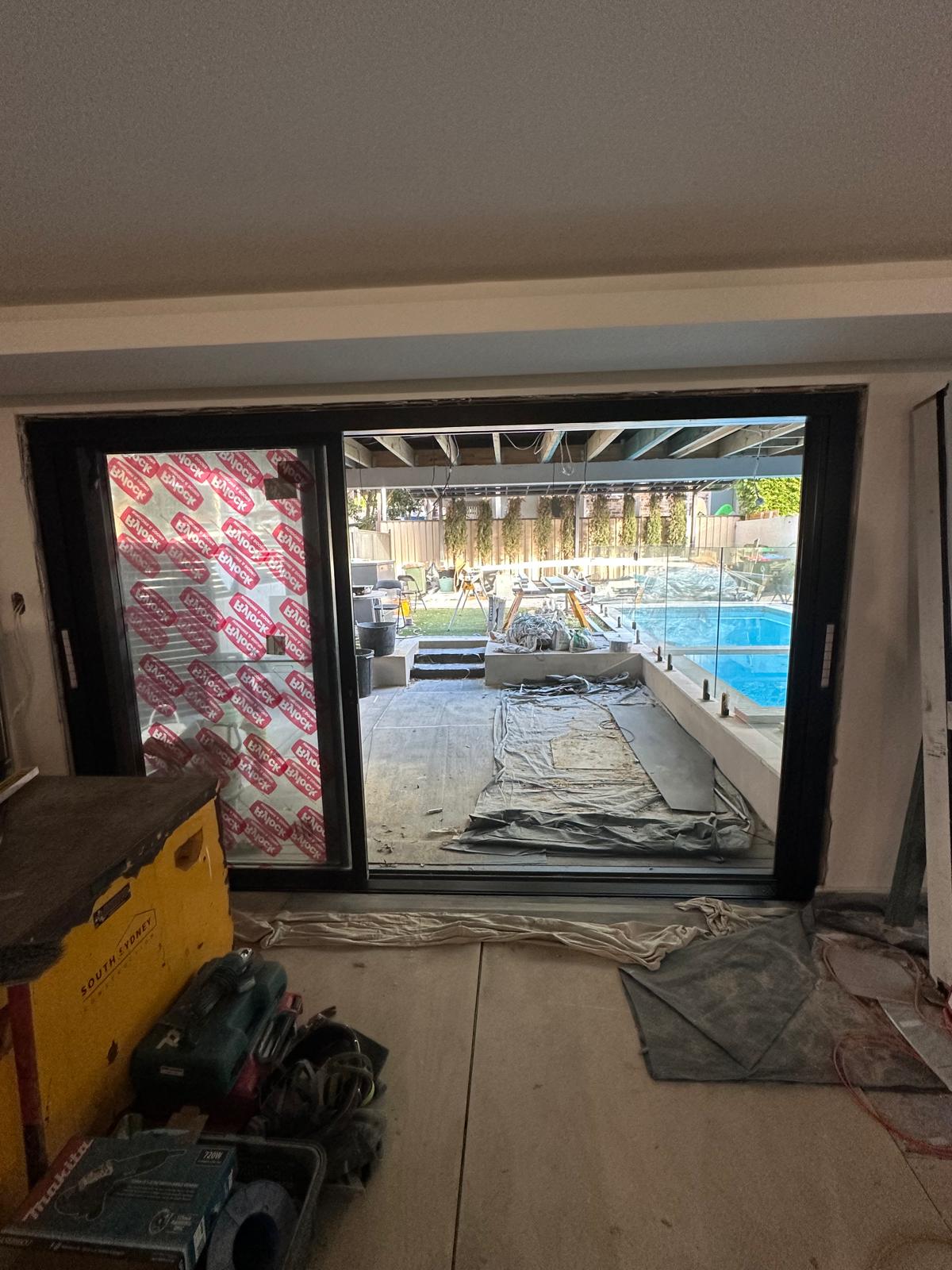 Motorised ZipSlide screen descending over an alfresco dining space
