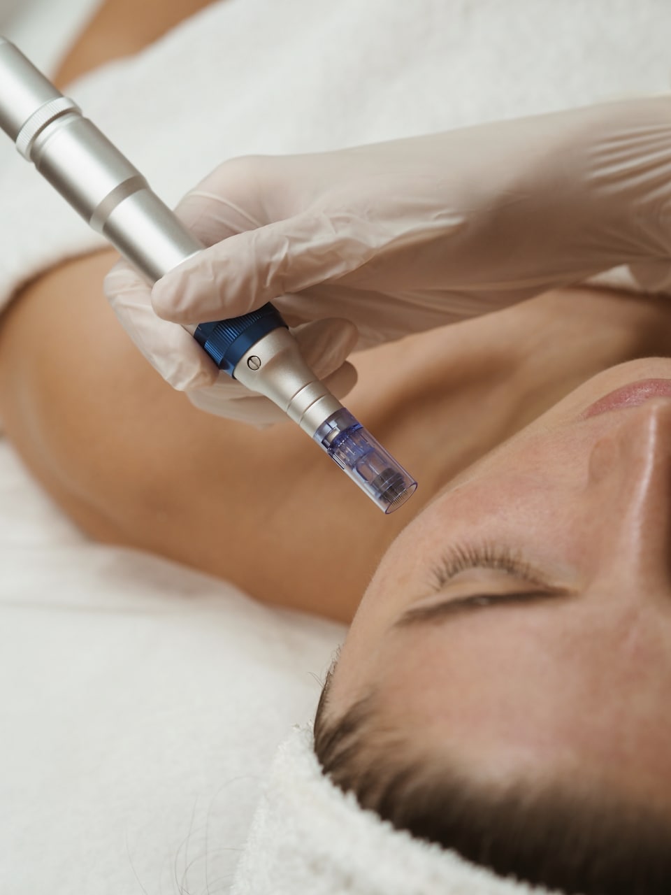Professional aesthetician in pristine clinic preparing for a skin consultation with elegant natural lighting