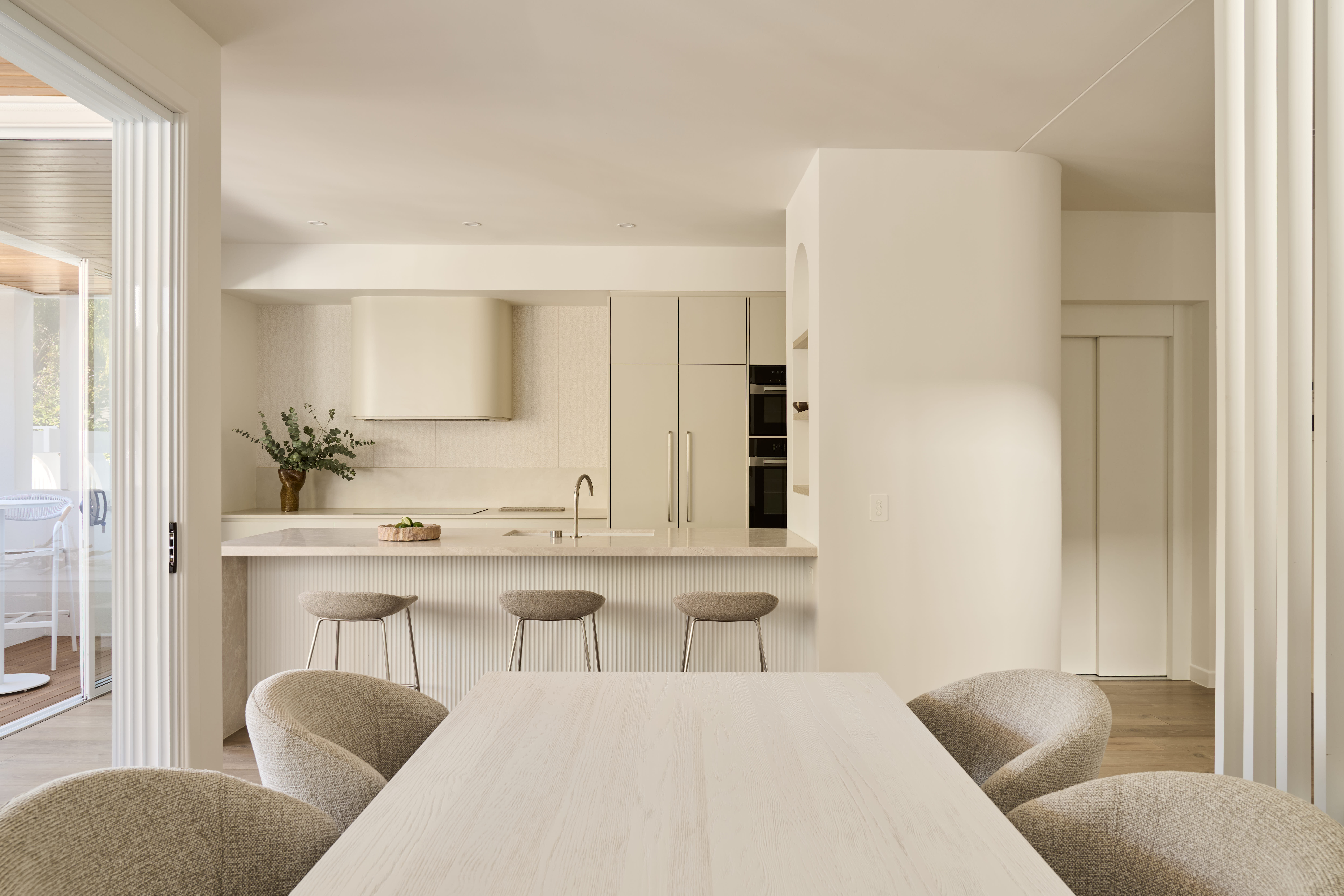 Luxury styled living room with a linen sofa, sculptural coffee table, layered neutral textiles and warm natural light