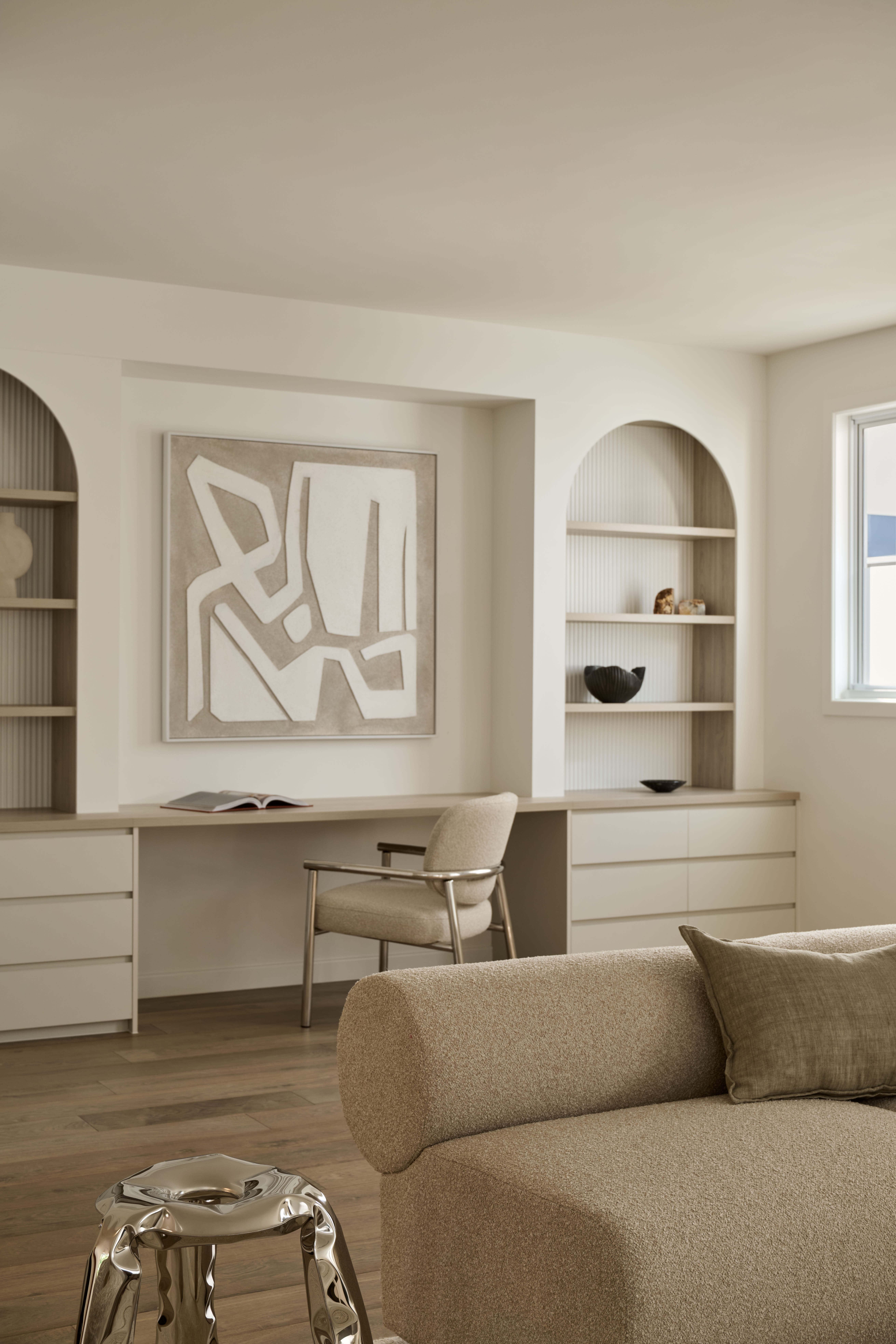 Elegant open plan dining area with timber table, upholstered chairs, statement pendant lighting and soft neutral styling